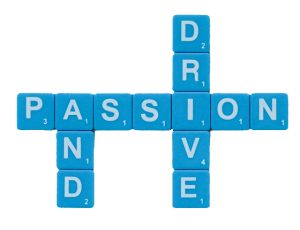 blue letter scrabble tiles with white text that reads "passion and drive"