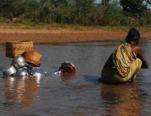 woman wading in water in India