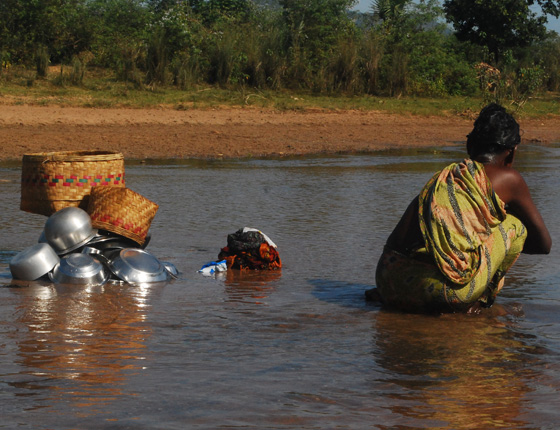 woman wading in water in India