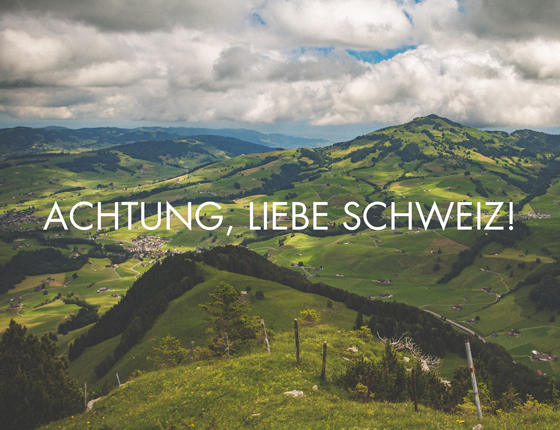Green hills and clouds with text overlay "ACHTUNG, LIEBE SCHWEIZ!"
