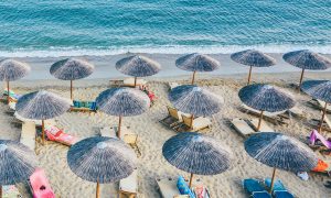 umbrellas and lounge chairs on a beach in Greece