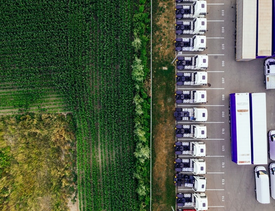 aerial view of crop field and trucks for food transport